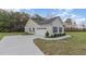 Features a spacious two car garage and extra long driveway with manicured landscaping at 11771 Raleigh Rd, Four Oaks, NC 27524