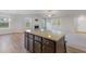 Modern kitchen island with granite countertop, storage, and a seamless flow into the living spaces at 11771 Raleigh Rd, Four Oaks, NC 27524