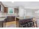 Modern kitchen features an island with granite countertops and stainless steel appliances at 11771 Raleigh Rd, Four Oaks, NC 27524