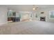 Open living space featuring a modern fireplace, neutral colors, and ample natural light at 11771 Raleigh Rd, Four Oaks, NC 27524
