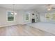 Inviting living room featuring vaulted ceilings, large windows, and an adjoining dining area at 11771 Raleigh Rd, Four Oaks, NC 27524