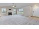 Spacious living room showcasing a fireplace, hardwood floors, and an abundance of natural light at 11771 Raleigh Rd, Four Oaks, NC 27524