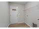 Bright mud room featuring gray walls, wood-look floors, and a coat rack by the entry door at 11771 Raleigh Rd, Four Oaks, NC 27524