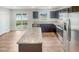 Modern kitchen features dark cabinets, granite countertops, stainless steel appliances, and a kitchen island at 1205 Bent Willow Dr, Durham, NC 27704