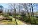 Beautiful backyard with mature trees, landscaping, and a deck at 134 Castlewood Dr, Cary, NC 27511