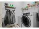 Functional laundry room equipped with modern washer and dryer units and storage shelves at 138 Tramway Cir, Angier, NC 27501