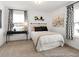 Inviting bedroom with two windows, carpet floors, lamp and decorative accents at 141 N District Ave # 295, Clayton, NC 27527