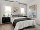 Bright bedroom featuring large windows with white curtains and modern furnishings at 141 N District Ave # 295, Clayton, NC 27527