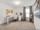 Bright home office featuring white desk, custom pegboards, sewing mannequin, and abundant natural light at 141 N District Ave # 295, Clayton, NC 27527