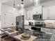 The kitchen features white cabinets, black granite countertops, and stainless steel appliances at 141 N District Ave # 295, Clayton, NC 27527