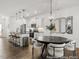 Modern kitchen flows into dining area, featuring white cabinets and granite countertops at 141 N District Ave # 295, Clayton, NC 27527