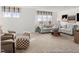 A light-filled living room showcases a neutral palette with comfortable seating and carpet floors at 141 N District Ave # 295, Clayton, NC 27527