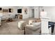 This living room includes stylish ottomans, neutral paint, carpet floors and modern decor at 141 N District Ave # 295, Clayton, NC 27527