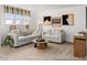 Cozy living room with large windows, two sofas, carpet floors and an area rug at 141 N District Ave # 295, Clayton, NC 27527