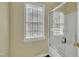 Bright bathroom with a shower-tub combination and natural light streaming through the window at 1968 Shadow Glen Dr, Raleigh, NC 27604