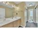 Bathroom featuring a large mirror, double sinks, and a closet at 1968 Shadow Glen Dr, Raleigh, NC 27604