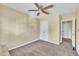 Bedroom highlighting neutral paint, a window, ceiling fan, and closet access at 1968 Shadow Glen Dr, Raleigh, NC 27604