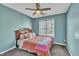 Cozy bedroom with a ceiling fan, a window with blinds, and soothing blue walls at 1968 Shadow Glen Dr, Raleigh, NC 27604