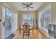 Bright dining area featuring hardwood floors, sliding doors, and a wooden dining table at 1968 Shadow Glen Dr, Raleigh, NC 27604