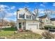 Charming two-story home with a two-car garage, a manicured lawn and green shutters at 1968 Shadow Glen Dr, Raleigh, NC 27604