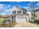 Charming two-story home with a two-car garage, a manicured lawn and green shutters at 1968 Shadow Glen Dr, Raleigh, NC 27604