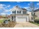 Beautiful two-story home featuring white siding, green shutters, and an attached garage at 1968 Shadow Glen Dr, Raleigh, NC 27604