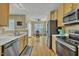 Kitchen featuring stainless steel appliances and hardwood floors at 1968 Shadow Glen Dr, Raleigh, NC 27604