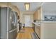 Well-lit kitchen with stainless steel appliances and light wood cabinets at 1968 Shadow Glen Dr, Raleigh, NC 27604