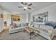 Spacious living room featuring plush sofas, a ceiling fan, and an open layout at 1968 Shadow Glen Dr, Raleigh, NC 27604