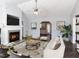 Bright living room featuring a fireplace, ceiling fan, and hardwood floors at 203 Patterdale Pl, Benson, NC 27504