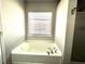 Corner bathtub area features a window at 204 Hillview Dr, Durham, NC 27703