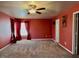 Large carpeted bedroom with ceiling fan and curtains at 204 Hillview Dr, Durham, NC 27703