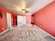 Large carpeted bedroom with ceiling fan and curtains at 204 Hillview Dr, Durham, NC 27703