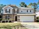 Charming two-story home with a brick and gray facade, well-maintained lawn, and an attached two-car garage at 204 Hillview Dr, Durham, NC 27703