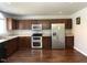 Spacious kitchen with stainless steel appliances, plenty of counter space and dark wood cabinetry at 204 Hillview Dr, Durham, NC 27703