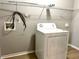 Laundry room features a white washing machine and wire shelving for storage at 204 Hillview Dr, Durham, NC 27703