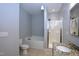Bright bathroom showcasing tub, walk-in shower, tiled floor, and granite countertop on vanity at 2144 Waterview Dr, Graham, NC 27253