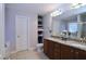 Bright bathroom featuring double sinks, granite countertops, and ample storage space at 2144 Waterview Dr, Graham, NC 27253