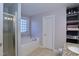 Bathroom featuring a soaking tub, tiled floor, and open shelving for linens and storage at 2144 Waterview Dr, Graham, NC 27253