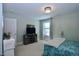 A well-lit bedroom with carpet, ceiling light fixture, and a closet door to the left at 2144 Waterview Dr, Graham, NC 27253