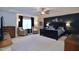 Spacious bedroom featuring tray ceiling, carpet, large window, and accent wall at 2144 Waterview Dr, Graham, NC 27253