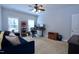 Comfortable bedroom featuring a ceiling fan, bright windows and a cozy sitting area at 2144 Waterview Dr, Graham, NC 27253