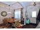 Inviting dining room featuring a coffered ceiling, stylish lighting, and an elegant table setting at 2144 Waterview Dr, Graham, NC 27253