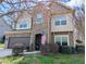 Inviting two-story home with stone and siding, an arched entryway, and neat front yard landscaping at 2144 Waterview Dr, Graham, NC 27253