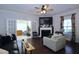 The spacious living room boasts hardwood floors, a fireplace, and french doors leading to a sunroom at 2144 Waterview Dr, Graham, NC 27253