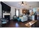 Open-concept living room with a fireplace, modern furnishings, and hardwood floors at 2144 Waterview Dr, Graham, NC 27253