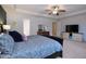 Main bedroom with blue patterned bedding, tray ceilings, and natural light at 2144 Waterview Dr, Graham, NC 27253