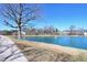 Scenic pond featuring a fountain and well-maintained landscaping in a charming neighborhood at 2144 Waterview Dr, Graham, NC 27253