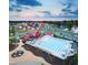 An aerial view of a community pool, barn-themed clubhouse, lounge chairs, and neighborhood homes at 217 Inspiration Way Way, Fuquay Varina, NC 27526