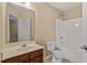 Well-lit bathroom with a single sink vanity and shower-tub combo, offering convenience and style at 2306 Stoney Spring Dr, Raleigh, NC 27610